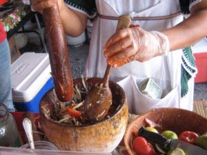 The salad is made in a deep clay mortar. 